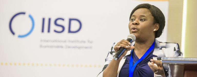 A speaker uses a microphone during a meeting