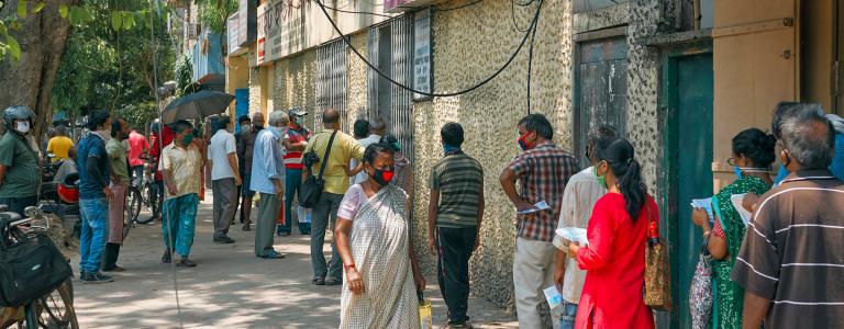 Line up people in street waiting to pay domestic electricity bill during COVIDs