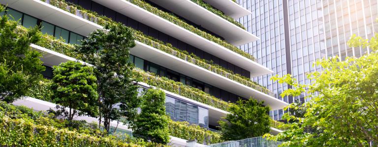 A tall apartment building with trees and other natural elements