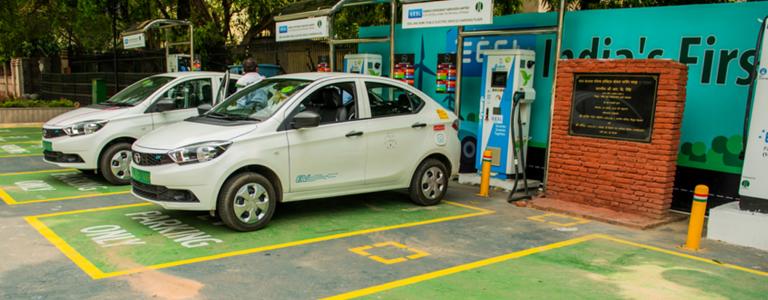 Two electric vehicles sit in "EV Parking Only" spaces.