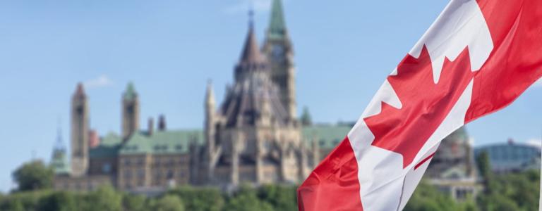 Canadian flag in front of the Canadian Parliament