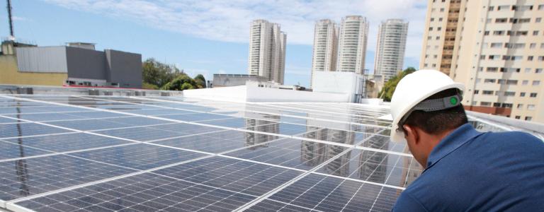 Worker installing solar panels