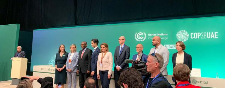 Members of a new international coalition to phase out fossil fuel subsidies stand at a COP 28 press conference.