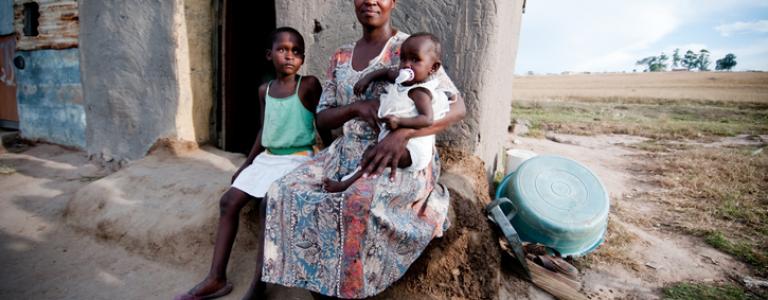 African family sitting in front of a hut.jpg