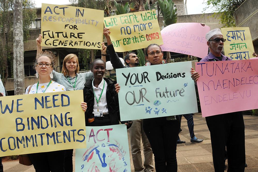 Activists hold signs