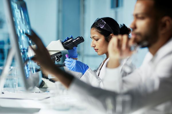 Lab techs pulling data into a computer